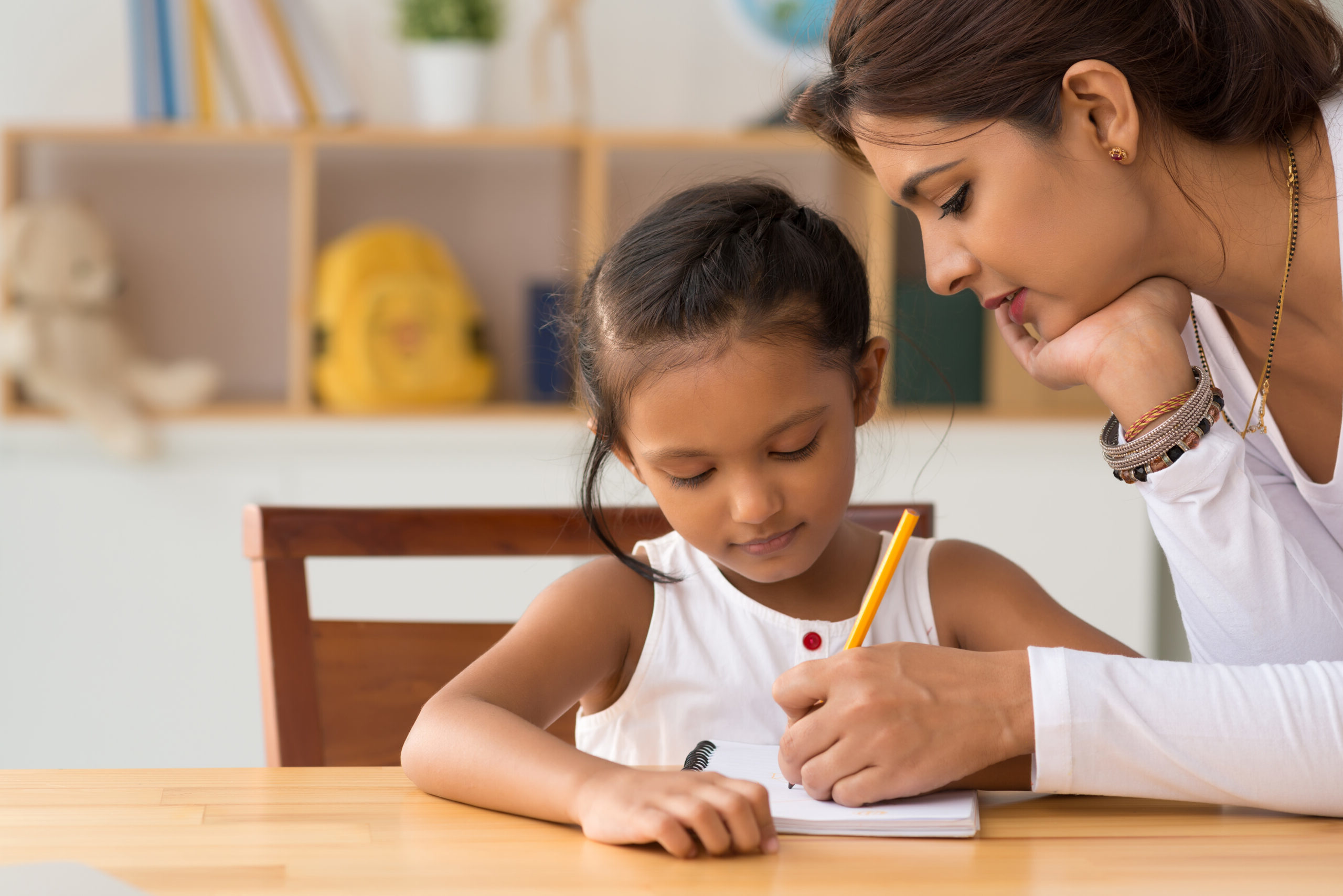 Woman-helping-daughter-with-homework